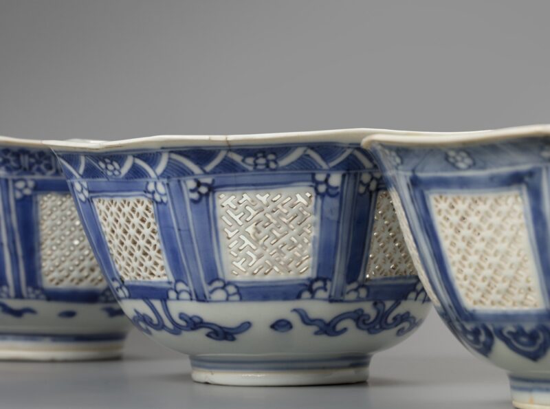 A set of three matching octagonal reticulated blue and white bowls – detail