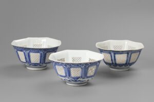 A set of three matching octagonal reticulated blue and white bowls