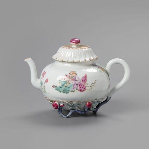 A Chinese famille rose teapot with cover with applied flowers branches
