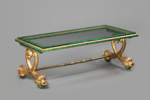 A gilt-bronze mounted glass coffee table with dolphin legs