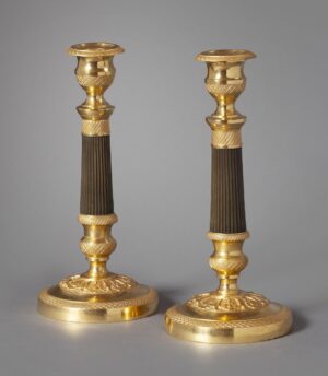 A pair of ormolu and bronze Charles Dix candlesticks. 