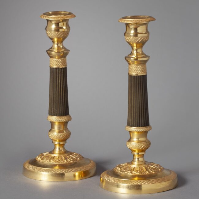 A pair of ormolu and bronze Charles Dix candlesticks. 